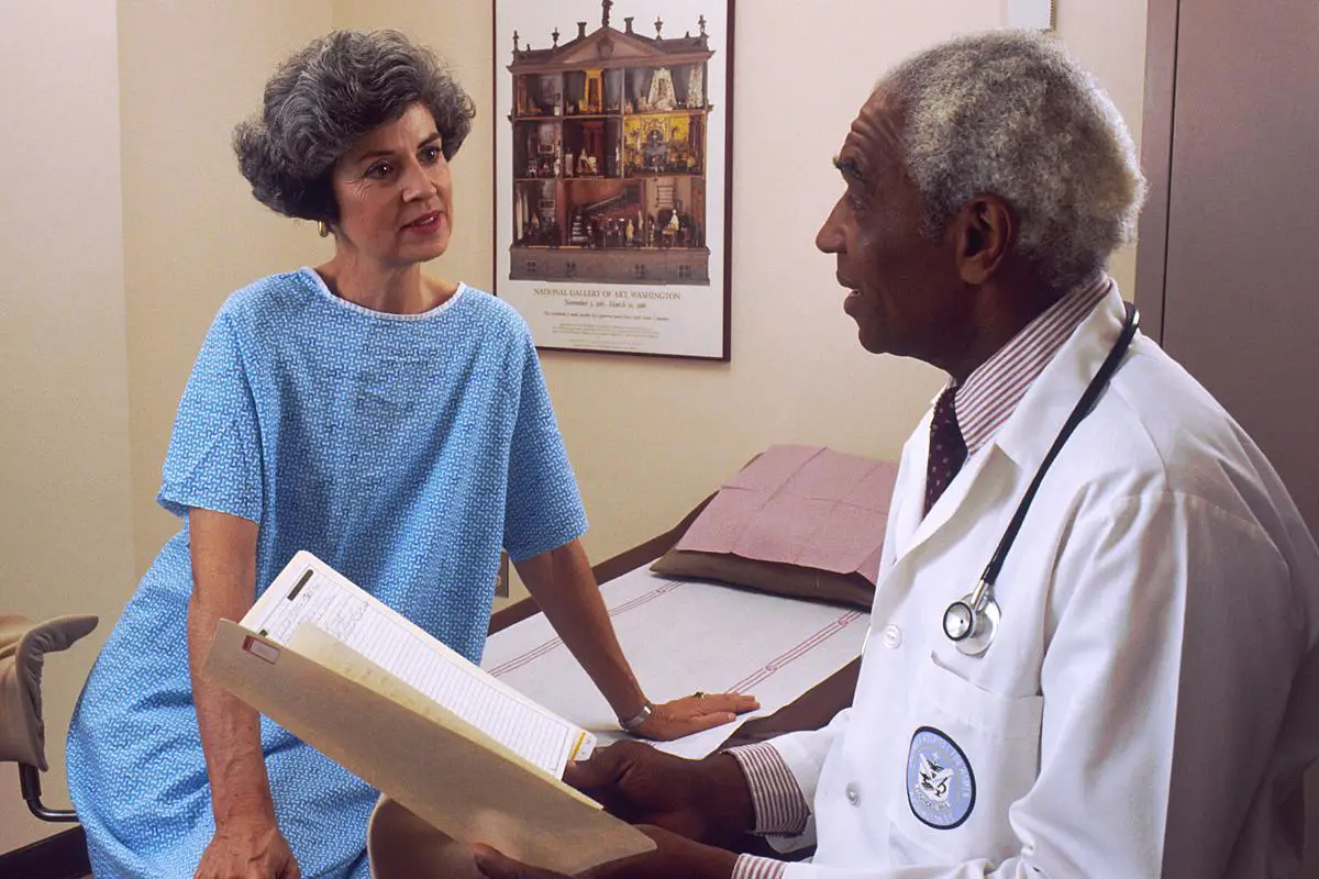 A doctor having a face-to-face consultation with a patient, representing the personal touch and specialized care offered by traditional healthcare.