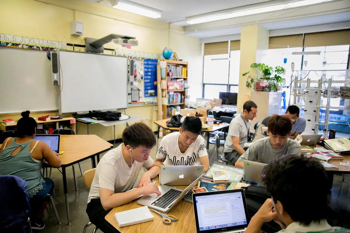 A hybrid classroom setup for a machine learning program, showing both in-person and remote students