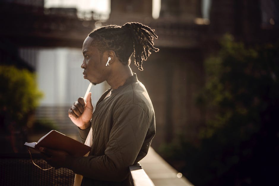 Image of a student sitting at a desk, looking thoughtful and inspired.