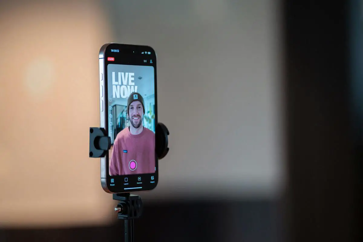 Smartphone screen showing YouTube avatar creation process with person recording themselves for AI avatar generation